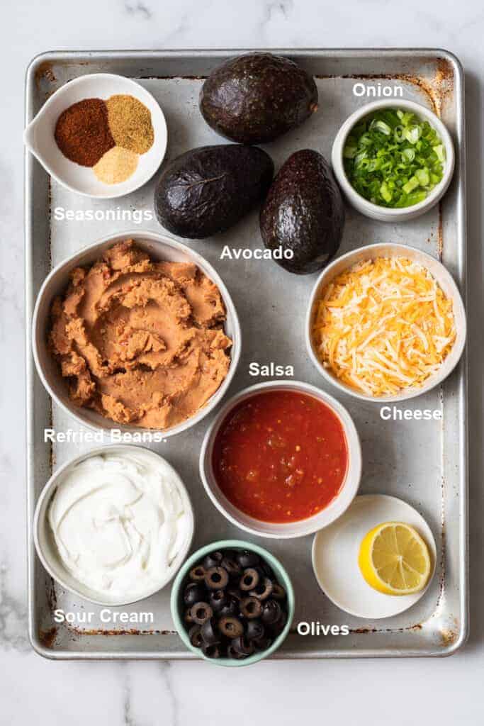 The ingredients needed to make 7-layer bean dip.