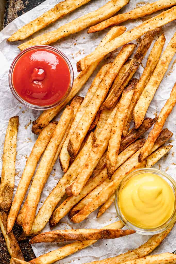 Air Fryer French Fries served on a tray with dipping sauces.