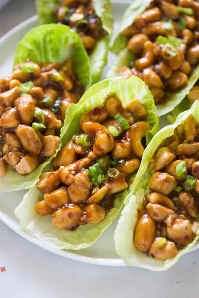 A Cashew Chicken mixture inside of romaine heart lettuce wrap. 