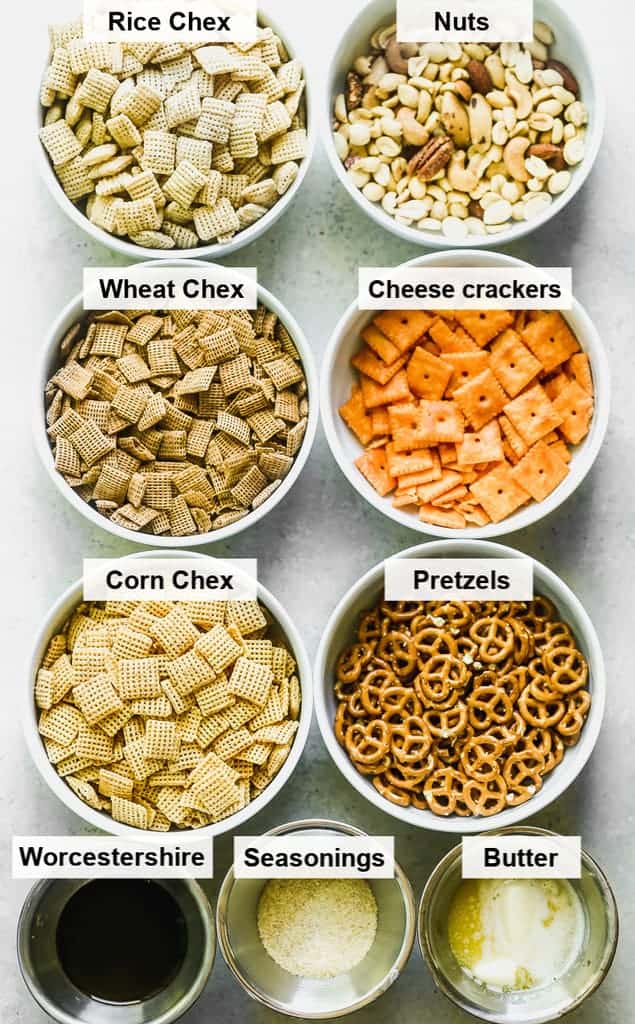 The ingredients for Chex mix in individual labeled bowls.