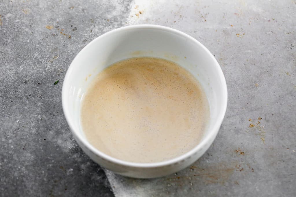 Yeast proofing in a small bowl.