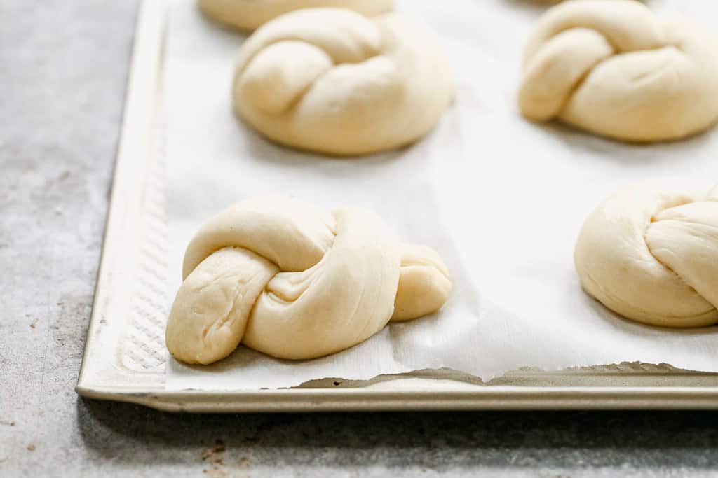 Garlic knot dough rising on a pan for the second rise.