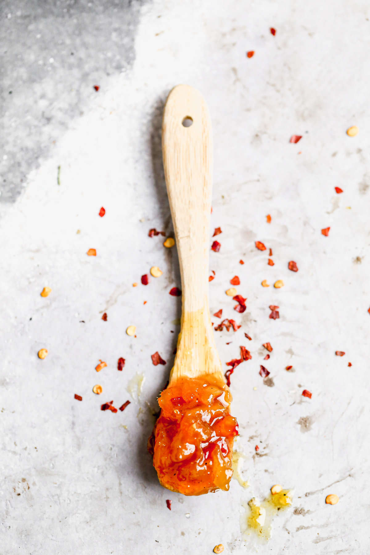 A spoon filled with homemade mango chutney.