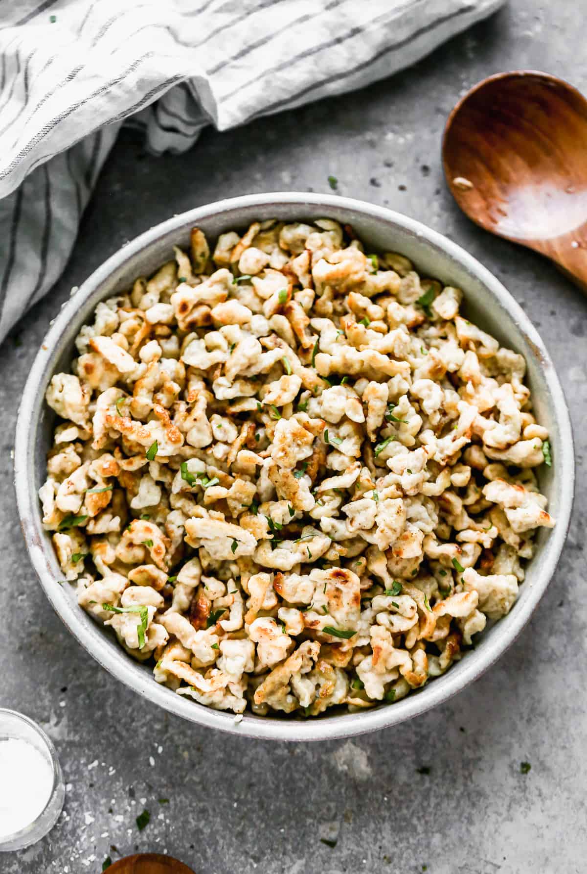 A bowl filled with an easy German Spaetzle recipe tossed in butter, ready to serve.