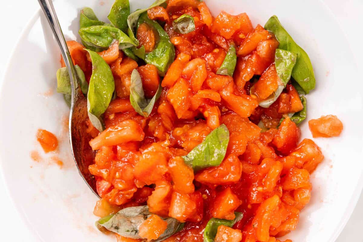 A bowl of tomato and basil mixture for homemade bruschetta.