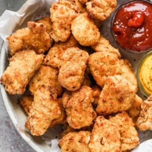 Air Fryer Chicken Nuggets served on a plate with dipping sauce.