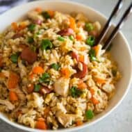 Peruvian Fried Rice served in a white bowl with chopsticks.