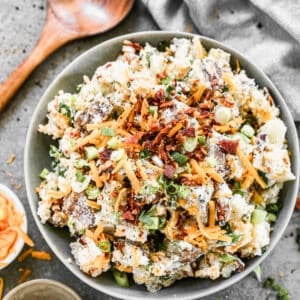 A serving bowl filled with easy Baked Potato Salad, ready to serve.