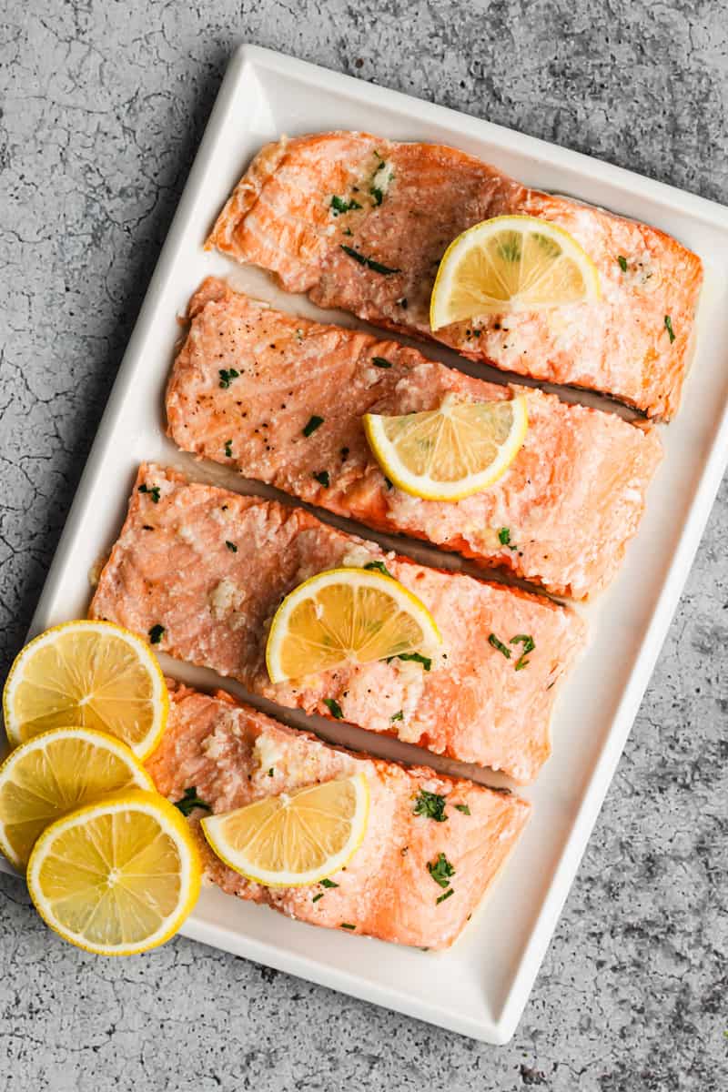 An easy baked salmon recipe on a platter, cut into four fillets and ready to serve. 