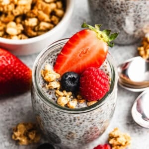 Overnight Chia Pudding recipe in a jar topped with granola and berries, ready to enjoy.