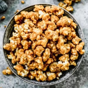 A bowl of a homemade Caramel Popcorn recipe with the perfect crunchy chewy texture.