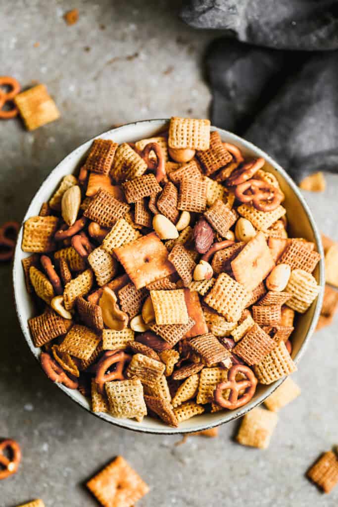 A bowl of homemade Chex Mix with Chex, nuts, pretzels, baked in a simple sauce.