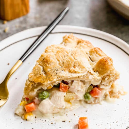 A slice from a Homemade Chicken Pot Pie on a plate showing the yummy filling inside.