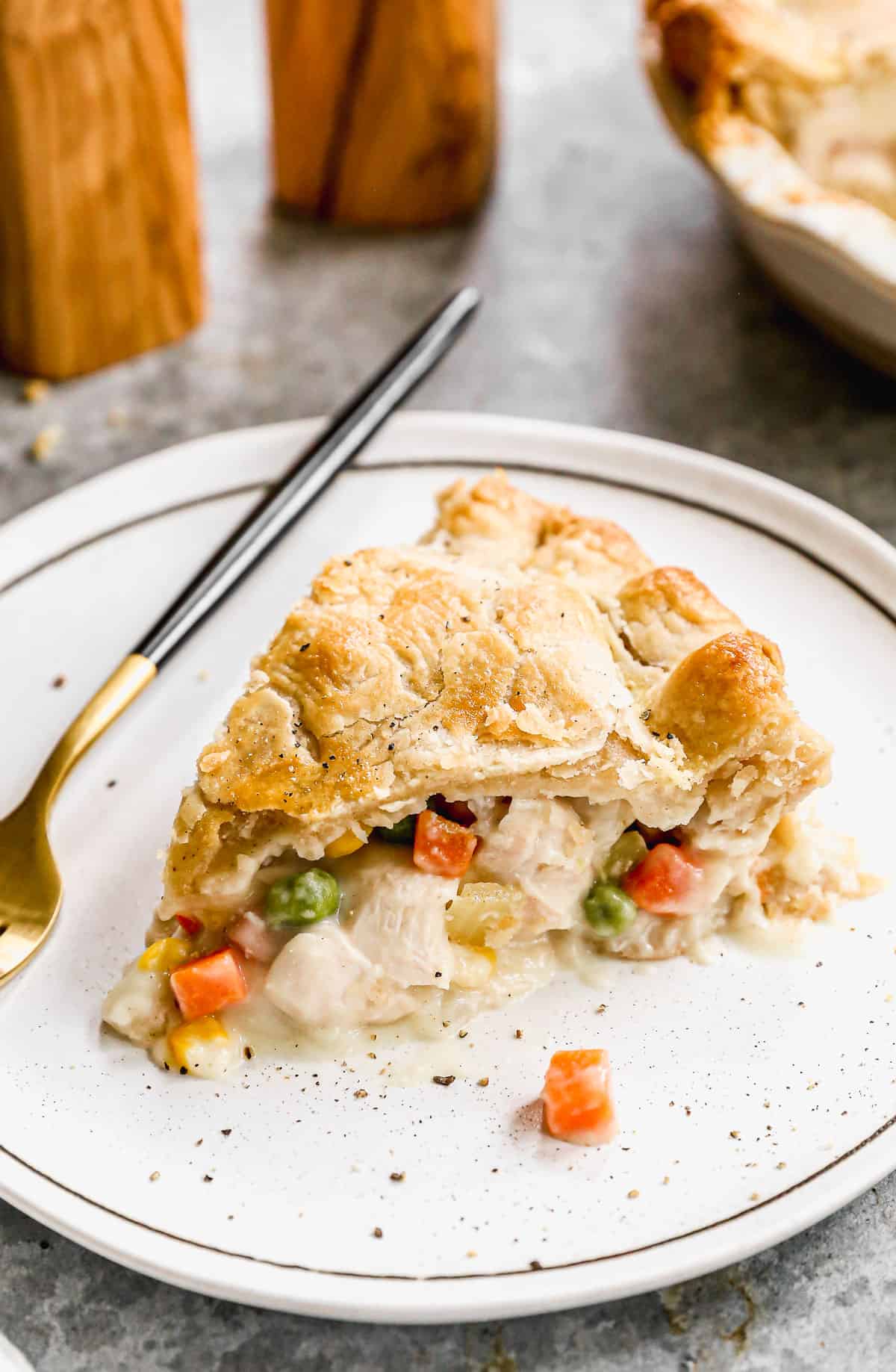 A slice from a Homemade Chicken Pot Pie on a plate showing the yummy filling inside.  