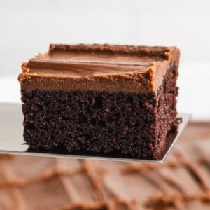 A moist piece of Chocolate Mayonnaise Cake being lifted by a spatula, ready to serve.