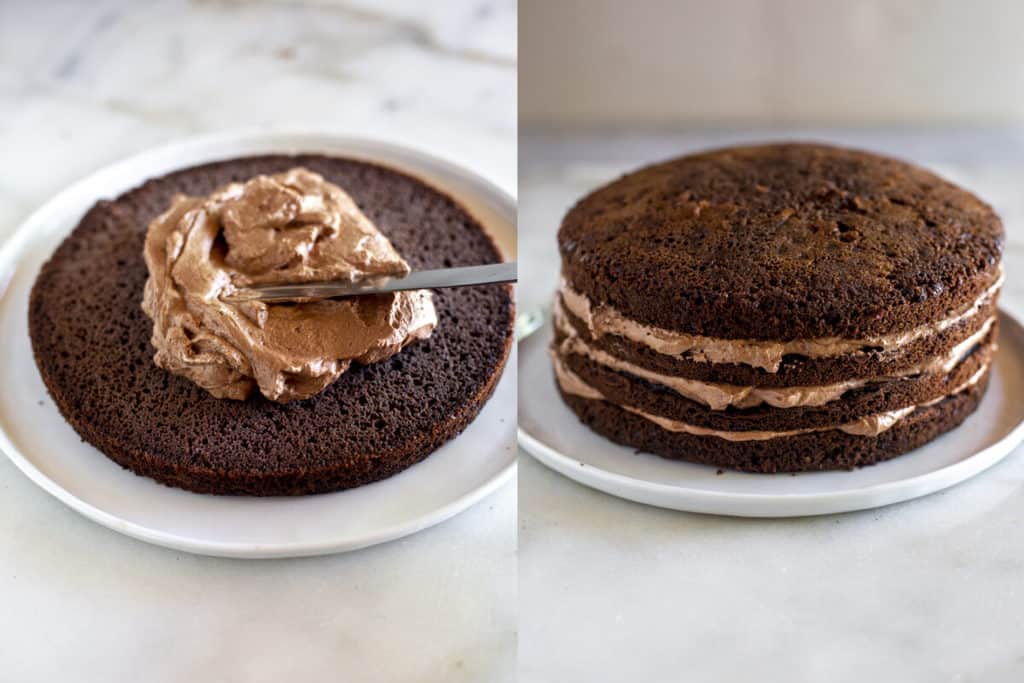 A chocolate cake round on a plate with mousse added on top, then additional cake layers stacked, with mousse between each layer.