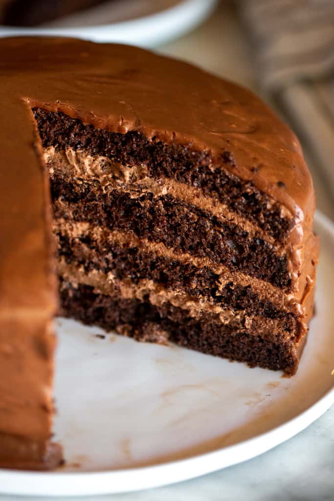 A chocolate mousse cake with a slice removed from it.