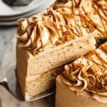 A slice of Cookie Butter Cake being removed to show the moist cake inside.