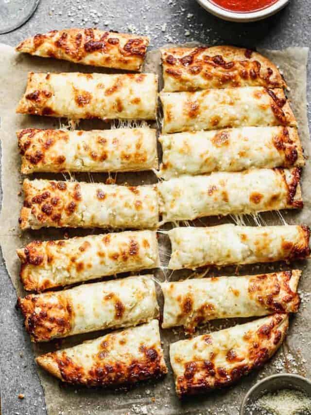 Homemade cheesy breadsticks cut into slices.