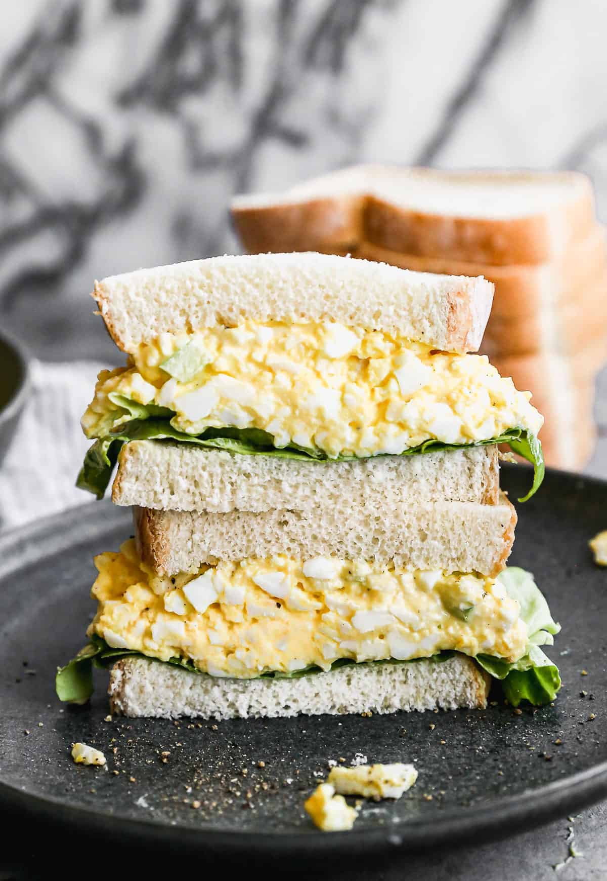 Egg salad sandwich served on a plate.