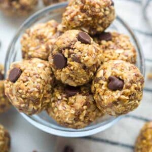 Homemade energy balls stacked on top of each other in a bowl.