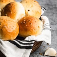 A basket full of freshly baked garlic rolls.