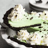 A slice of an easy grasshopper pie recipe being lifted out of a pie pan.