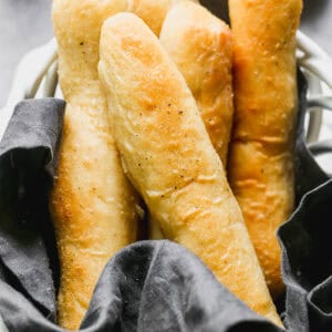 A basket of Olive Garden Breadsticks, freshly homemade and ready to enjoy.