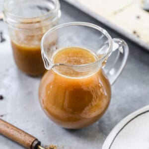 A small pitcher filled with buttermilk syrup, ready to enjoy over pancakes.