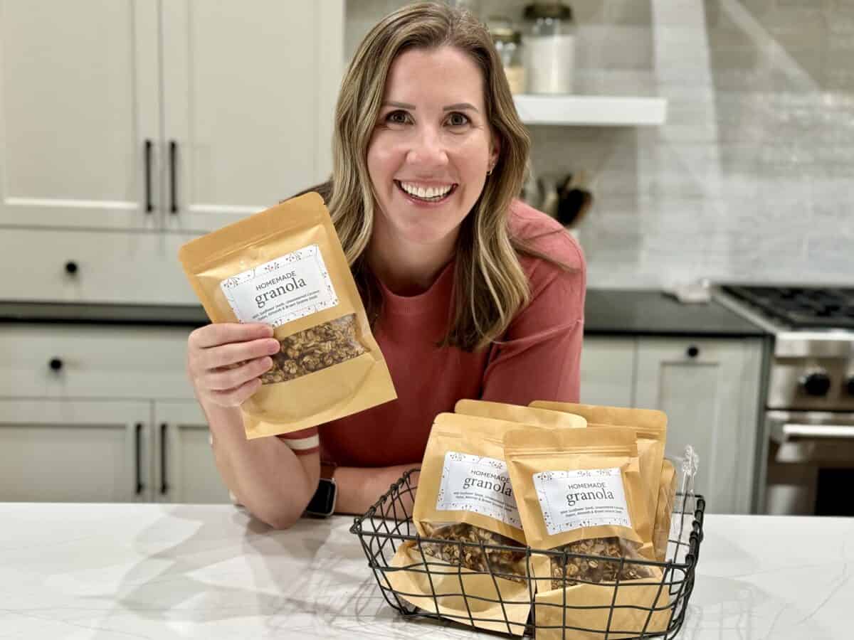 Lauren Allen holding a package of homemade granola, labeled and ready to gift to neighbors and friends.