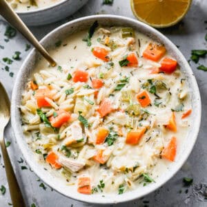 A creamy Lemon Chicken Orzo Soup recipe packed with chicken and vegetables in a bowl ready to enjoy.