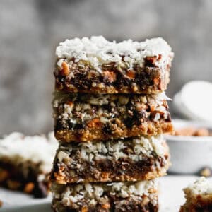 An easy Magic Bar recipe with the layered bars cut and stacked on top of each other.