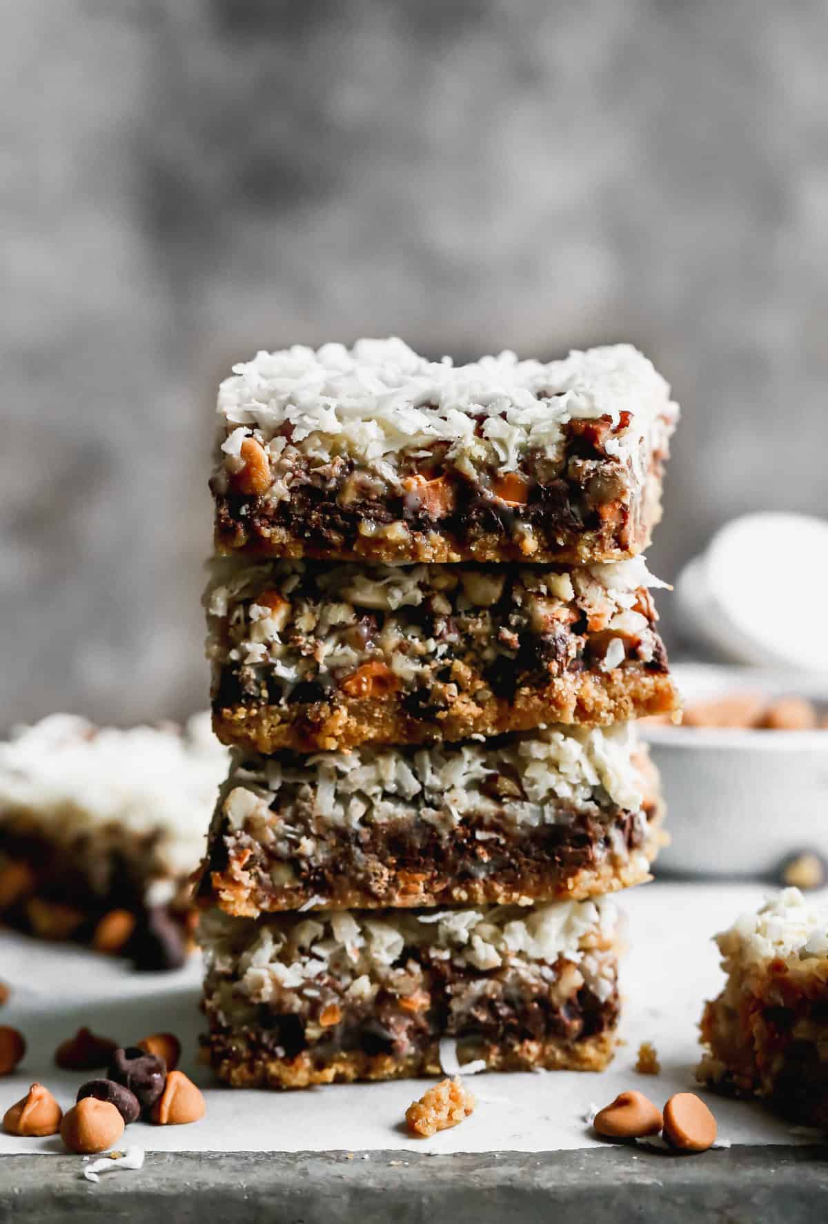 An easy Magic Bar recipe with the layered bars cut and stacked on top of each other. 