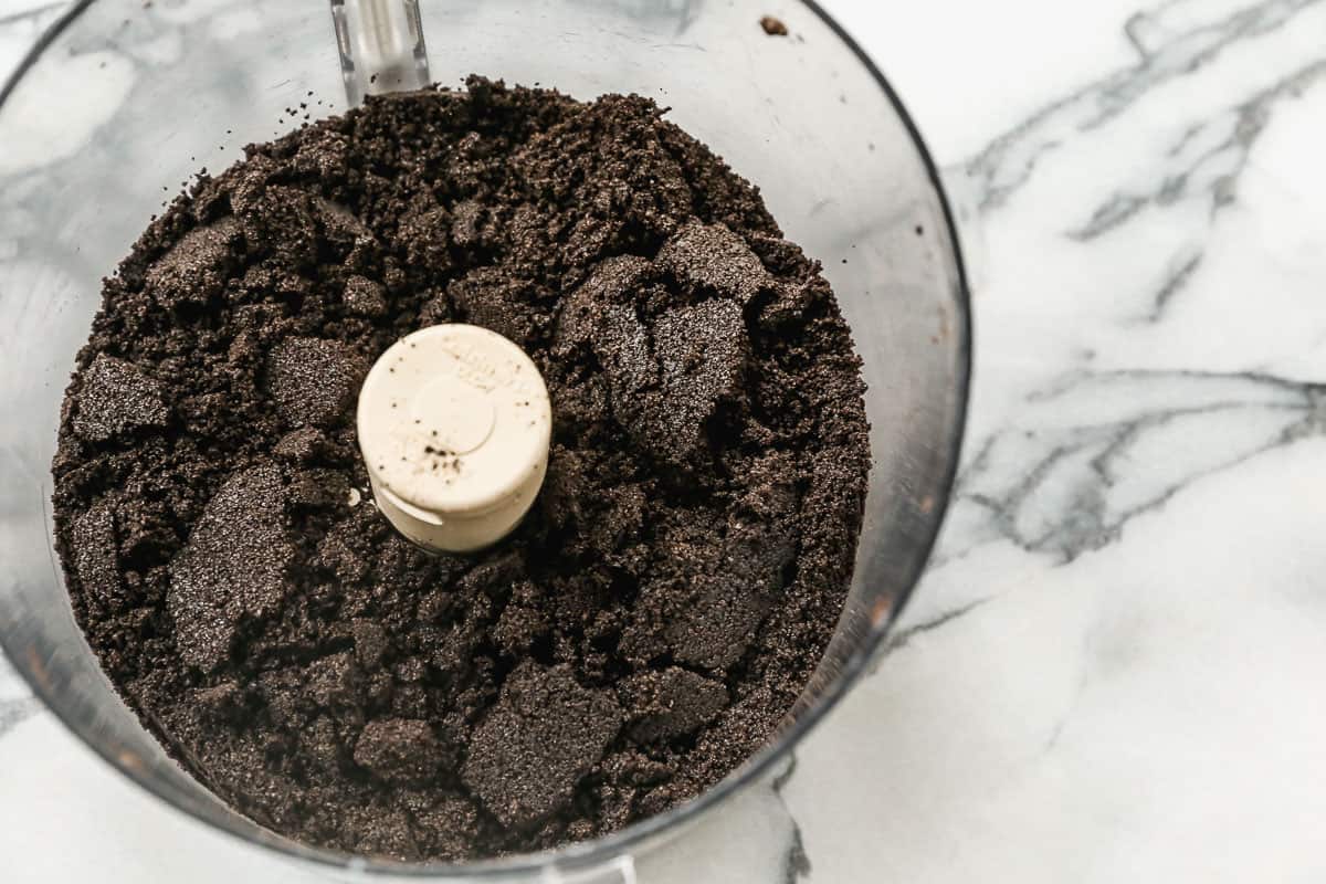 Oreo crumbs inside a food processor.