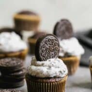 Oreo cupcakes with Oreo frosting and a whole Oreo cupcake pressed into the frosting.