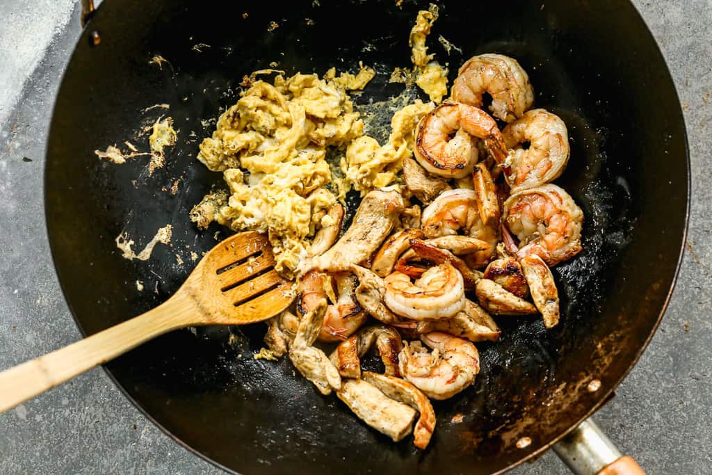 Eggs added to a wok, cooking pad thai.