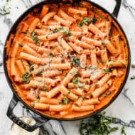 Creamy Pasta Sauce in a large skillet topped with freshly grated parmesan cheese and fresh chopped basil.