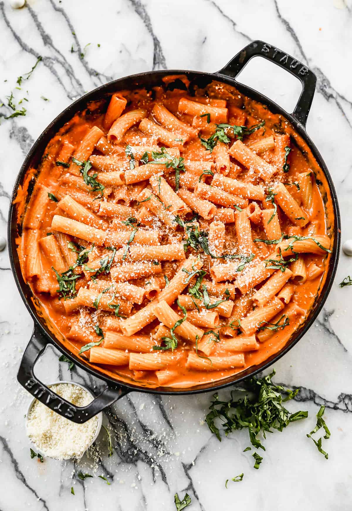 Creamy Pasta Sauce in a large skillet topped with freshly grated parmesan cheese and fresh chopped basil. 