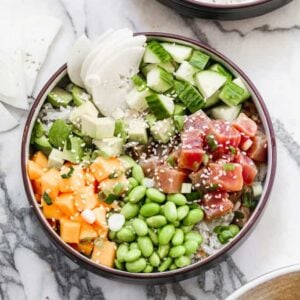 A homemade poke bowl with marinated ahi tuna, coconut rice, edamame, mango, cucumber and avocado.