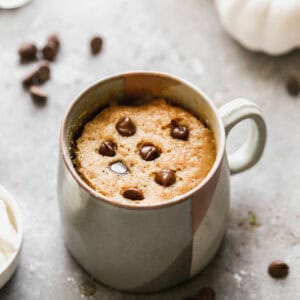 An easy pumpkin mug cake with chocolate chips ready to be eaten.