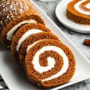 An easy Pumpkin Roll recipe with three slices cut to show the perfect spiral.