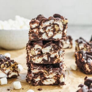 Three pieces of a chocolate rocky road recipe stacked on top of each other.