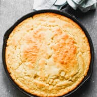 A Southern Skillet Cornbread recipe fresh out of the oven and ready to slice and enjoy.