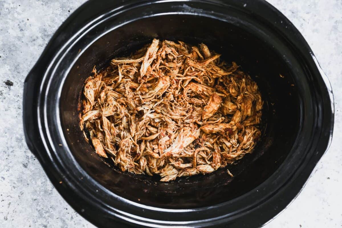 Crockpot shredded chicken taco meat in a slow cooker.