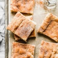 Snickerdoodle Bars cut into squares, on a baking sheet.