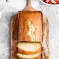 Overhead photo of a loaf of Sour Cream Pound Cake with three pieces sliced.