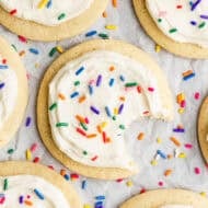 An easy Sugar Cookie recipe, frosted with cream cheese frosting and topped with rainbow sprinkles.